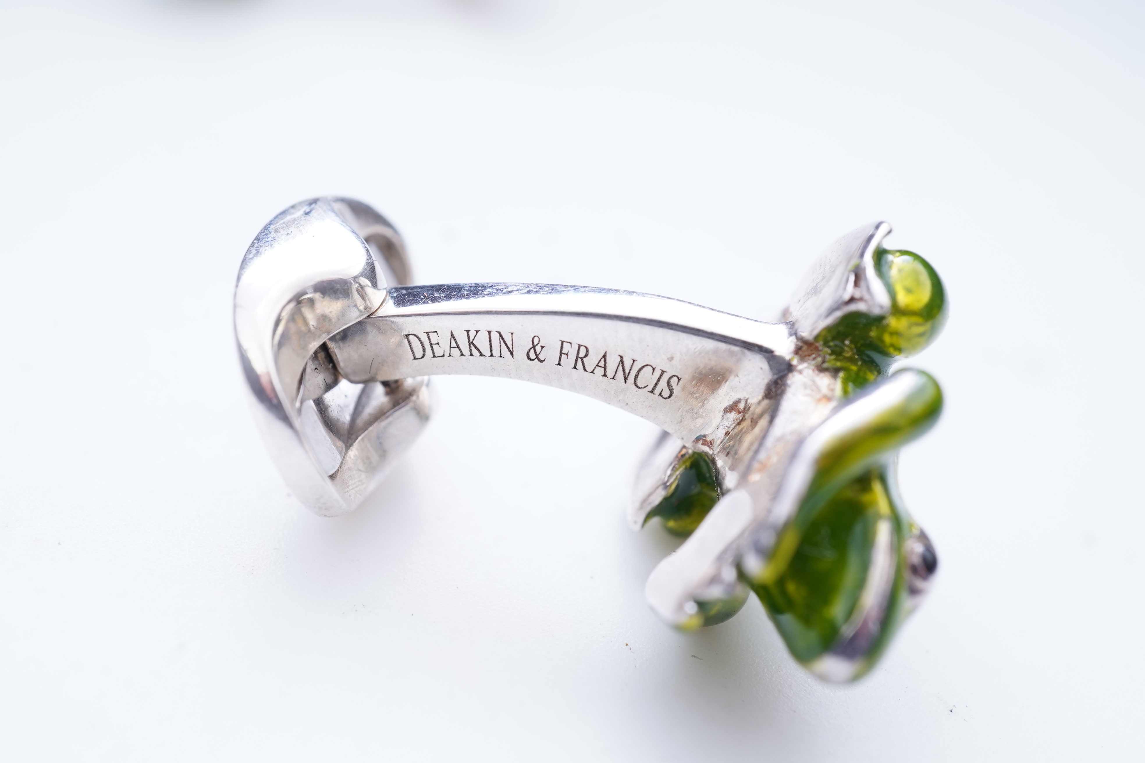 A modern pair of silver and polychrome enamel set oval cufflinks, 18mm.